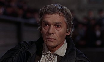 Movie still from “A Man for All Seasons” (1966), directed by Fred Zinnemann – An older man wearing a black jacket and a white shirt; Close Up shot, High angle