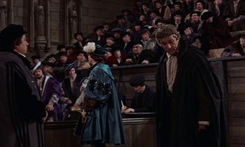Movie still from “A Man for All Seasons” (1966), directed by Fred Zinnemann – A man and a woman in front of an audience in front of an audience; Medium shot, High angle