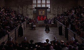 Movie still from “A Man for All Seasons” (1966), directed by Fred Zinnemann – A group of people sitting in front of an audience; Extreme Wide shot, High angle