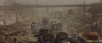 Movie still from “A Mighty Heart” (2007), directed by Michael Winterbottom – A busy street filled with lots of traffic; Extreme Wide shot, High angle