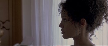 Movie still from “A Mighty Heart” (2007), directed by Michael Winterbottom – A person's face in a room; Close Up shot, Over the shoulder angle