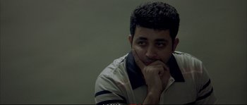 Movie still from “A Mighty Heart” (2007), directed by Michael Winterbottom – A man with his chin resting on his hand; Close Up shot, Low angle