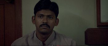 Movie still from “A Mighty Heart” (2007), directed by Michael Winterbottom – A person wearing a shirt and tie; Close Up shot, Low angle