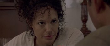 Movie still from “A Mighty Heart” (2007), directed by Michael Winterbottom – A person with curly black hair; Close Up shot, Over the shoulder angle