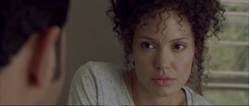 Movie still from “A Mighty Heart” (2007), directed by Michael Winterbottom – A person with curly black hair; Close Up shot, Over the shoulder angle