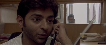 Movie still from “A Mighty Heart” (2007), directed by Michael Winterbottom – A person talking on a phone; Close Up shot, Over the shoulder angle