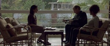 Movie still from “A Mighty Heart” (2007), directed by Michael Winterbottom – A man and a woman sitting in front of each other; Wide shot, Over the shoulder angle
