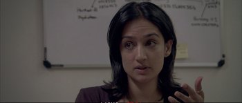 Movie still from “A Mighty Heart” (2007), directed by Michael Winterbottom – A person sitting in front of a whiteboard; Close Up shot, Over the shoulder angle