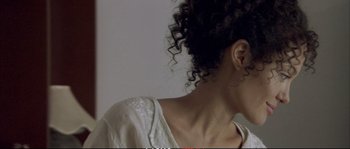 Movie still from “A Mighty Heart” (2007), directed by Michael Winterbottom – A woman's face and neck; Close Up shot, Over the shoulder angle