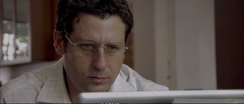 Movie still from “A Mighty Heart” (2007), directed by Michael Winterbottom – A person using a computer; Close Up shot, Low angle