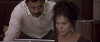 Movie still from “A Mighty Heart” (2007), directed by Michael Winterbottom – A man and a woman looking at a computer screen; Close Up shot, High angle