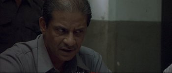 Movie still from “A Mighty Heart” (2007), directed by Michael Winterbottom – An older man with a beard and a mustache; Close Up shot, Low angle