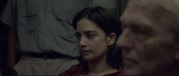 Movie still from “A Mighty Heart” (2007), directed by Michael Winterbottom – A person sitting on a bed; Close Up shot, Over the shoulder angle