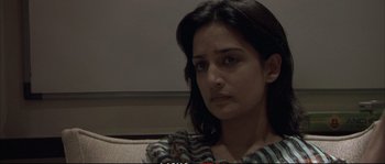 Movie still from “A Mighty Heart” (2007), directed by Michael Winterbottom – A person sitting on a couch; Close Up shot, High angle