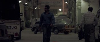 Movie still from “A Mighty Heart” (2007), directed by Michael Winterbottom – A man walking down the street at night; Wide shot, Low angle