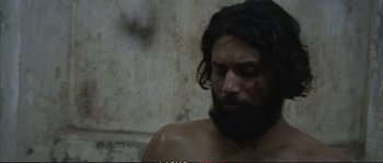 Movie still from “A Mighty Heart” (2007), directed by Michael Winterbottom – A man with long hair and a long beard; Close Up shot, Low angle