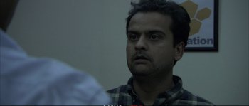 Movie still from “A Mighty Heart” (2007), directed by Michael Winterbottom – A person looking at something; Close Up shot, Over the shoulder angle