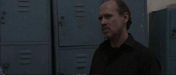 Movie still from “A Mighty Heart” (2007), directed by Michael Winterbottom – A man standing in front of two metal lockers; Close Up shot, Over the shoulder angle