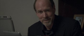 Movie still from “A Mighty Heart” (2007), directed by Michael Winterbottom – A person wearing a suit and tie; Close Up shot, Over the shoulder angle