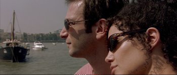 Movie still from “A Mighty Heart” (2007), directed by Michael Winterbottom – A man and a woman wearing sun glasses; Close Up shot, Low angle