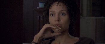Movie still from “A Mighty Heart” (2007), directed by Michael Winterbottom – A person with her hand to her face; Close Up shot, Over the shoulder angle