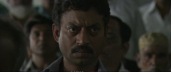 Movie still from “A Mighty Heart” (2007), directed by Michael Winterbottom – A person with a beard and mustache; Close Up shot, Low angle