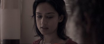 Movie still from “A Mighty Heart” (2007), directed by Michael Winterbottom – A person wearing a red shirt; Close Up shot, Low angle