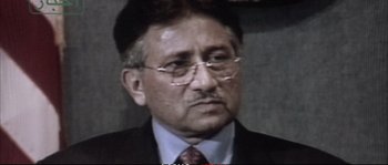 Movie still from “A Mighty Heart” (2007), directed by Michael Winterbottom – An older man wearing glasses and a suit and tie; Close Up shot, Low angle