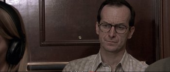 Movie still from “A Mighty Heart” (2007), directed by Michael Winterbottom – A person wearing glasses; Close Up shot, Over the shoulder angle