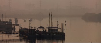 Movie still from “A Mighty Heart” (2007), directed by Michael Winterbottom – A boat in a body of water near a body of water; Extreme Wide shot, Low angle