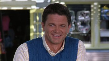 Movie still from “A Mighty Wind” (2003), directed by Christopher Guest – A person wearing a vest; Close Up shot, Over the shoulder angle