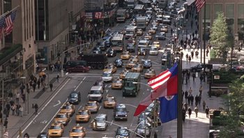 Movie still from “A Mighty Wind” (2003), directed by Christopher Guest – A busy city street filled with lots of traffic; Extreme Wide shot, High angle