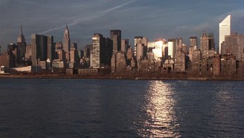 Movie still from “A Mighty Wind” (2003), directed by Christopher Guest – A view of a city skyline from across a body of water; Extreme Wide shot, High angle