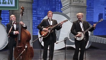 Movie still from “A Mighty Wind” (2003), directed by Christopher Guest – A group of men in tuxedos on a stage with guitars; Wide shot, Low angle