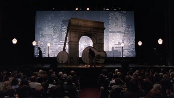 Movie still from “A Mighty Wind” (2003), directed by Christopher Guest – An audience is watching a performance on a stage; Extreme Wide shot, High angle