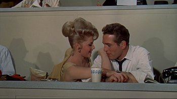 Movie still from “A New Kind of Love” (1963), directed by Melville Shavelson – A man and a woman sitting at a table; Medium shot, Over the shoulder angle