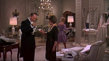 Movie still from “A New Kind of Love” (1963), directed by Melville Shavelson – A man and a woman standing in front of a chandelier; Medium shot, Low angle
