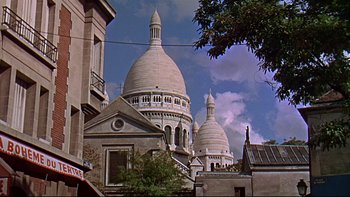 Movie still from “A New Kind of Love” (1963), directed by Melville Shavelson – A view of a building with two domes on top of it; Extreme Wide shot, Low angle