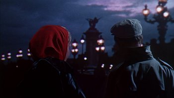Movie still from “A New Kind of Love” (1963), directed by Melville Shavelson – Two people standing in front of a statue at night; Medium shot, Low angle