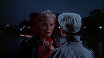 Movie still from “A New Kind of Love” (1963), directed by Melville Shavelson – A woman wearing a red scarf talking to a man; Close Up shot, Over the shoulder angle