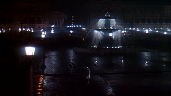 Movie still from “A New Kind of Love” (1963), directed by Melville Shavelson – A man standing in front of a fountain at night; Extreme Wide shot, High angle