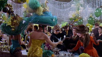 Movie still from “A New Kind of Love” (1963), directed by Melville Shavelson – A group of people sitting at a table with food; Medium shot, High angle