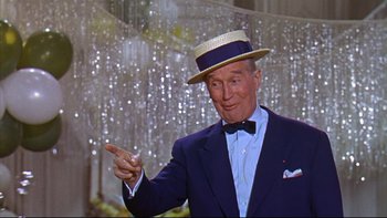Movie still from “A New Kind of Love” (1963), directed by Melville Shavelson – An older man wearing a suit and a straw hat; Medium shot, Low angle