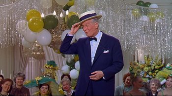 Movie still from “A New Kind of Love” (1963), directed by Melville Shavelson – An older man wearing a suit and a hat saluting in front of a group of people; Medium shot, Low angle