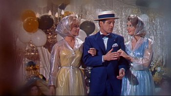 Movie still from “A New Kind of Love” (1963), directed by Melville Shavelson – A group of people standing next to each other in a room; Medium shot, Over the shoulder angle