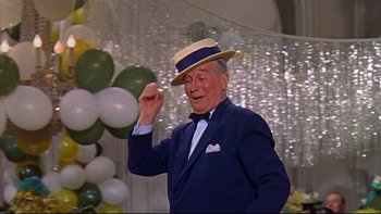 Movie still from “A New Kind of Love” (1963), directed by Melville Shavelson – An older man wearing a suit and a straw hat; Medium shot, Low angle