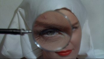 Movie still from “A New Kind of Love” (1963), directed by Melville Shavelson – A person with a magnifying glass; Extreme Close Up shot, Overhead angle