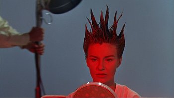 Movie still from “A New Kind of Love” (1963), directed by Melville Shavelson – A woman with a red wig on her head looking into a mirror; Close Up shot, Low angle