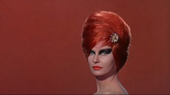 Movie still from “A New Kind of Love” (1963), directed by Melville Shavelson – A woman with red hair and a brooch on her head; Close Up shot, Low angle