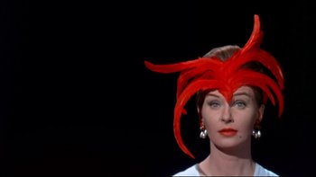 Movie still from “A New Kind of Love” (1963), directed by Melville Shavelson – A woman wearing a red hat and a white dress; Close Up shot, Low angle